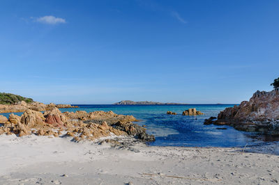 Scenic view of beach against blue sky