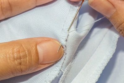 Midsection of tailor sewing textile