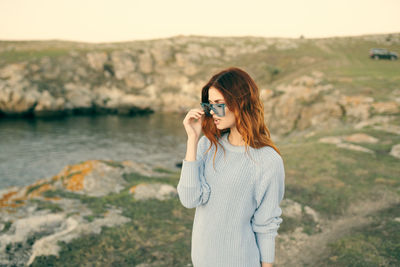 Young woman standing at camera