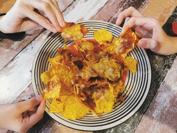 Midsection of woman holding food on table