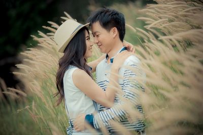 Couple embracing amidst plants