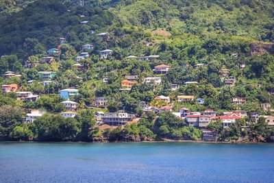 Scenic view of sea by buildings in city