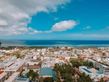 High angle view of cityscape by sea against sky