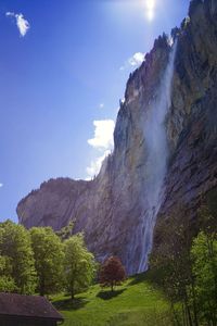 Scenic view of waterfall against sky