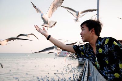 Man gesturing against seagulls