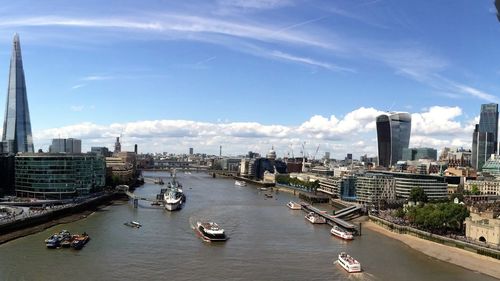 Boats in river with city in background