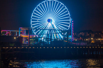 Illuminated ferris wheel at night