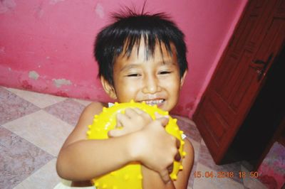 Portrait of a smiling girl holding while walking on floor