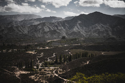 High angle view of land and mountains against sky