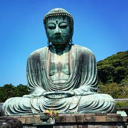 Low angle view of statue against clear blue sky