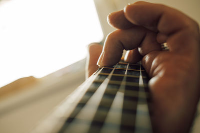 Cropped hand playing guitar