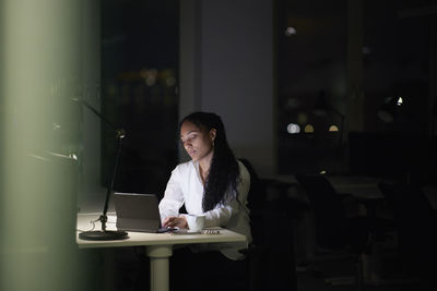 Woman working late in office