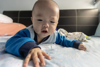 Portrait of cute baby lying on sofa