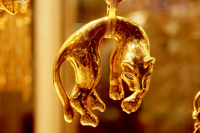 Close-up of gold colored pendant