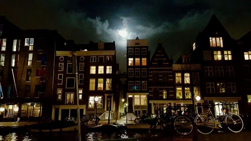 Buildings in city against cloudy sky