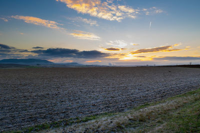 Scenic view of field against sky during sunset