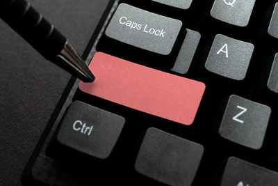 Close-up of pen on computer keyboard