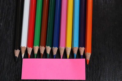 High angle view of multi colored pencils on shelf