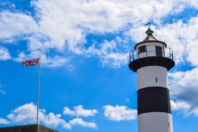 Low angle view of lighthouse against blue sky and clouds