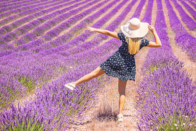 Close up of a young girl with a hat on her head between lavender in southern provence valensole 