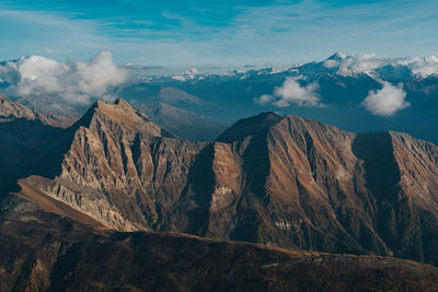 Scenic view of snowcapped mountains against cloudy sky