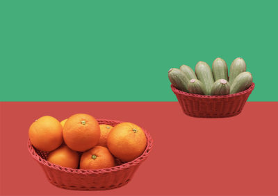 High angle view of fruits in container against blue background