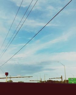 Low angle view of electricity pylon against sky