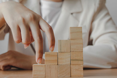 Midsection of man playing block