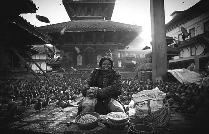 WOMAN SITTING IN MARKET