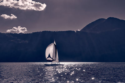 Sailboat in sea against sky