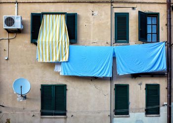 Low angle view of clothes drying against building