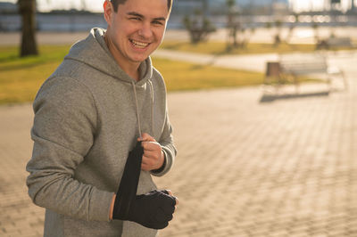 Portrait of young man standing in city