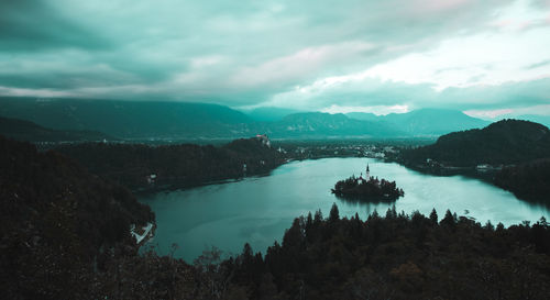 Scenic view of lake and mountains against sky