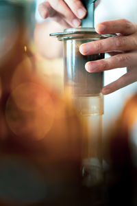 Close-up of hand holding glass bottle