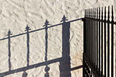 Shadow of railing on building wall
