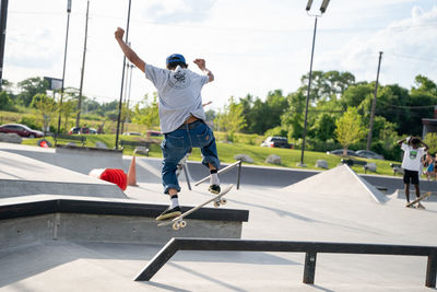 Rear view of man skateboarding on skateboard