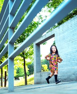 Full length of woman standing against trees