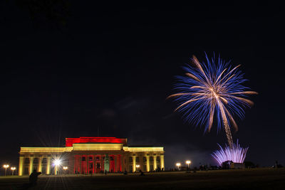 Low angle view of firework display at night