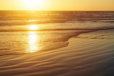 Scenic view of beach against sky during sunset