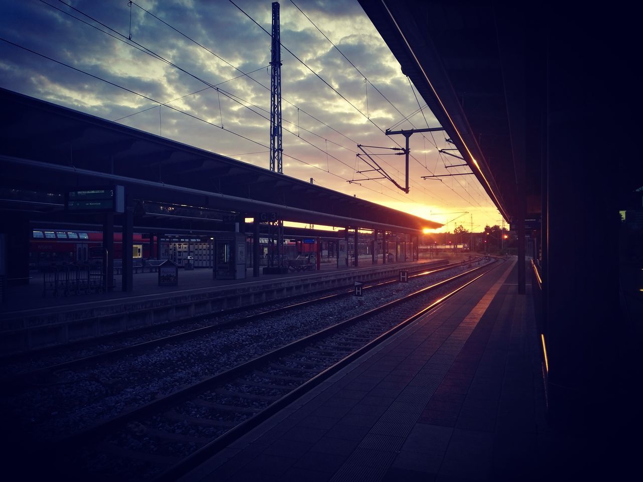 cloud - sky, sky, rail transportation, railroad track, transportation, track, mode of transportation, railroad station, public transportation, architecture, nature, railroad station platform, sunset, cable, electricity, travel, no people, technology, power line, train, outdoors, station, power supply