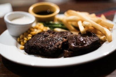 Close-up of steak in plate, beef steak, well done, rare