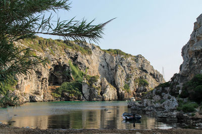 Small beach with turquoise water surrounded by cliffs and coves. cales coves, menorca.