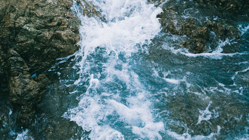 High angle view of water flowing through rocks