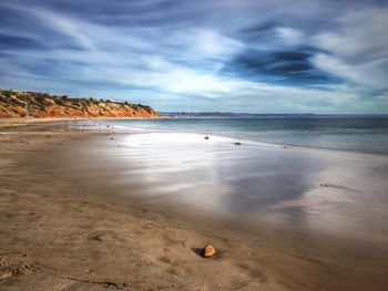 Scenic view of sea against cloudy sky