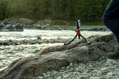 A man sets up a tripod for photography of landscape