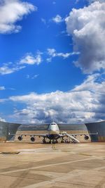 Rear view of people at airport against sky