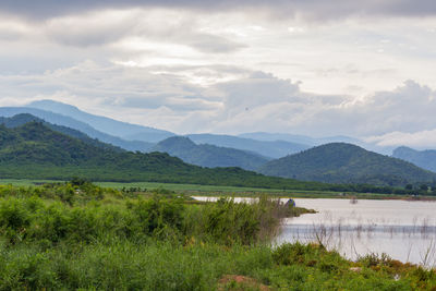 Scenic view of lake and mountains against sky