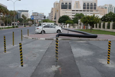 Cars on street against buildings in city