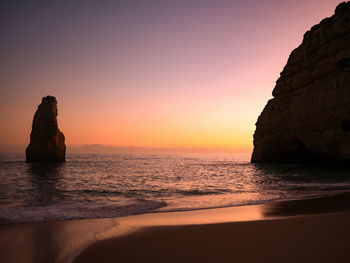 Sunset in front of the big lonely rock. algarve, portugal.