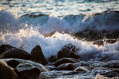 Waves splashing on rocks at shore